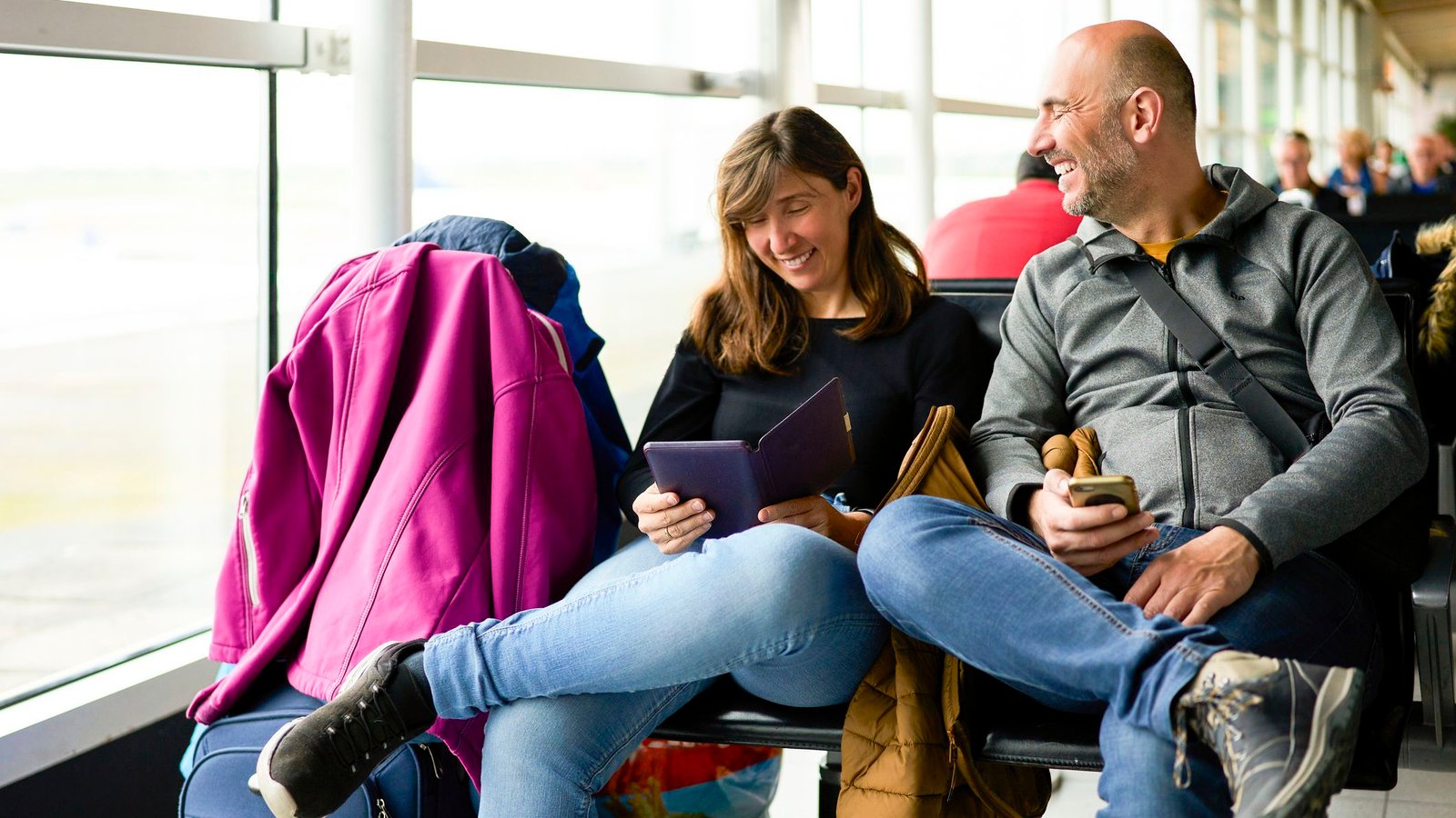 Couple waiting for their flight at the airport terminal